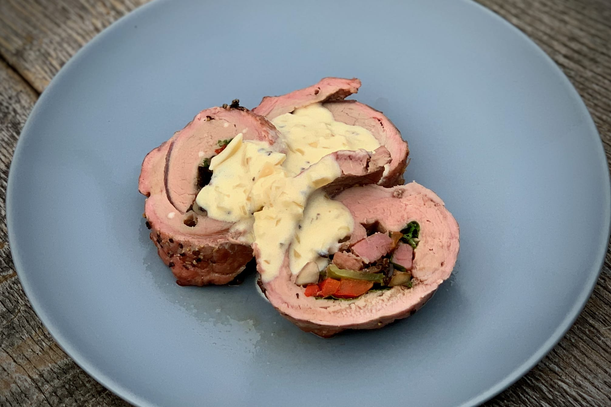 Stuffed Pork Tenderloin sliced with sauce
